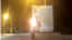 A screen grab from a video published on social media showing protesters setting fire to government propaganda banners in the southwestern Iranian city of Yasuj on February 20. 