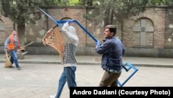 ანდრო დადიანს მეგობართან ერთად მიაქვს "ხორცის ფარი" საპატრიარქოს შესასვლელთან დასადგმელად.
