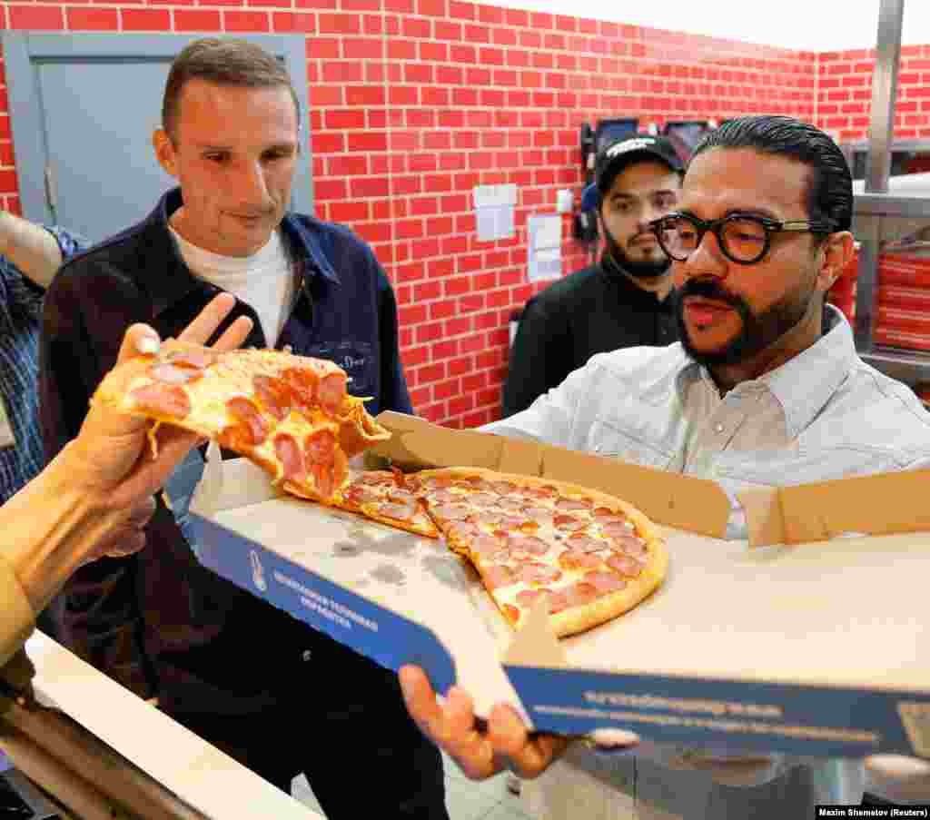 Russian restauranteur Anton Pinsky (left) and pro-Kremlin rapper Timati took over the assets of Domino's Pizza following the brand's exit from the country.  It is not the first Russian outlet of a multinational company to be "rebranded" by the pair.   