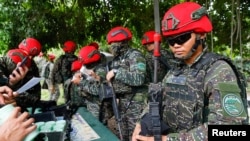 Taiwanese soldiers handle their guns during an anti-landing defense drill in New Taipei City.