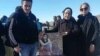 A family visits the grave of a protester killed in the unrest in the western city of Sanandaj on February 23.