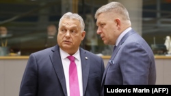 Hungarian Prime Minister Viktor Orban (left) speaks with his Slovakian counterpart Robert Fico prior to the start of a EU leaders summit in Brussels. (file photo)