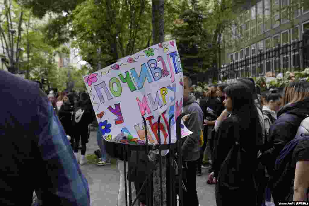 Transparent "Počivajte u miru, anđeli" na skupu ispred škole. 