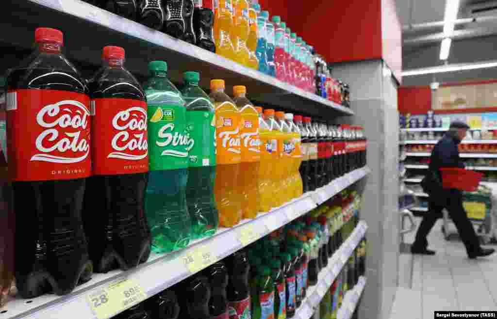Coca-Cola stopped production and sales in Russia in August 2022, leading to a flurry of similar drinks being produced domestically to fill the gap in the local market. This photo shows Russian-made Cool Cola, Street, and Fancy drinks on sale at a grocery store in Moscow.  