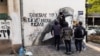 Serbia -- Group of young men are cleaning the street mural of convicted war criminal Ratko Mladic in Belgrade, November 15, 2021.