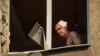 Wounded resident Volodymir, 66, looks out from inside his flat in an apartment building hit by a Russian military strike in Kramatorsk on July 7.