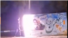 A protester sets fire to a government banner in Isfahan.