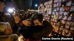 Mourners attend an outdoor vigil for the victims of Ukrainian passenger jet flight PS752 in Toronto, Canada, in January 2022.