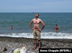 A Russian tourist from Saratov basks in the sun in Batumi.