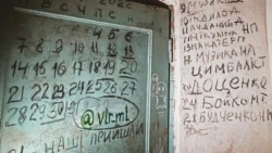 Дверь подвала, в котором российские военные удерживали жителей Ягодного Дверь подвала, в котором российские военные удерживали жителей Ягодного