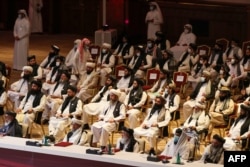 Members of the Taliban delegation attend the opening session of Afghan peace talks in the Qatari capital, Doha, on September 12.