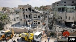 Rescue teams clear rubble in a neighbourhood in the northern Israeli village of Tamra, June 15, 2025.