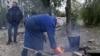 Ukraine - civilians with no access to gas or electricity build a fire in Kostyantynivka - screen grab