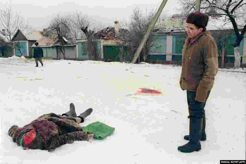 Ракетный обстрел настиг эту женщину на улице Грозного. Волонтеры из местных жителей и окрестных сел после бомбежек прочесывают улицы города. Если успевают, то вывозят тела до следующей бомбежки или хоронят неподалеку. 24 января 1995 года