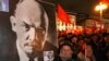 A Russian woman holding a portrait of Lenin during the traditional communist demonstration in downto