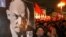 A Russian woman holding a portrait of Lenin during the traditional communist demonstration in downto