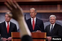 Liderul majorității din Senatul SUA, John Thune, alături de senatorii John Hoeven și John Barrasso, părăsesc o conferință de presă după un vot în Senat, cu doar câteva ore înainte ca o parte a guvernului federal să intre în blocaj.