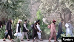 Newly freed AfghanTaliban prisoners walk inside the Pul-e-Charkhi prison in Kabul on August 13.