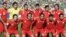 Rahman Rezaei (third right at back) poses with Iran's national soccer team in 2006.