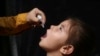 An Afghan girl is vaccinated during a polio-eradication campaign in Kabul on August 24.