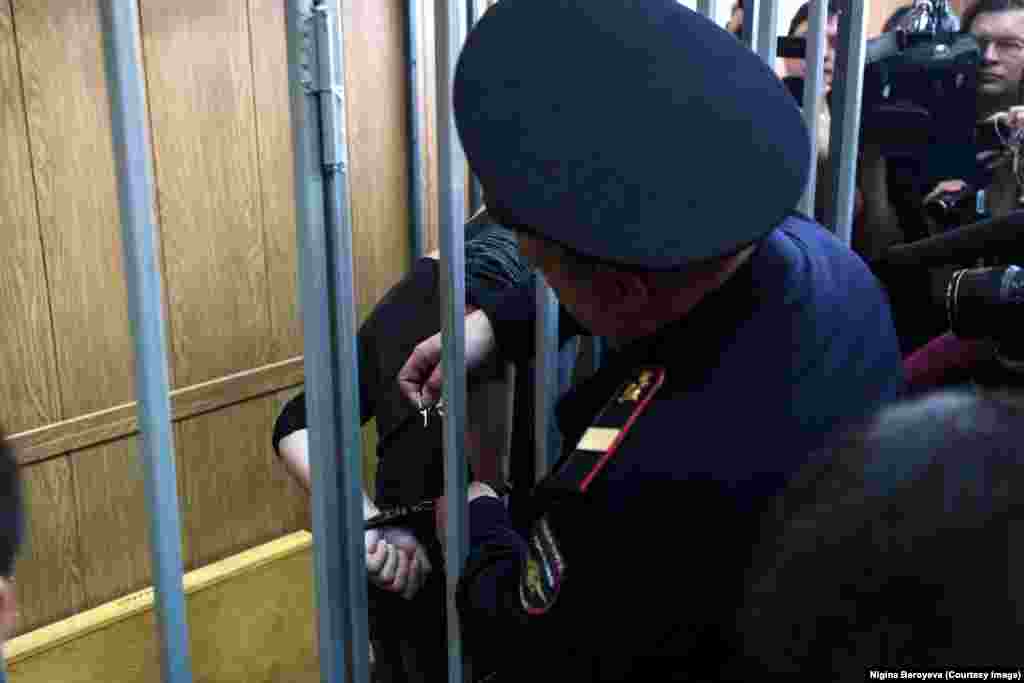 Сегодня, через семь месяцев после той ноябрьской ночи, Бероева протолкнлусь через забиты зал суда и сделала эту фотографию: с Павленского снимают наручники. Через несколько минут он вышел на улицу свободным человеком. Бероева говорит, что это не окончание для художника, который противостоит российским властям: "Я не удивлюсь, если эта акция продолжится".