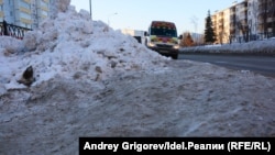 Проезжая часть улицы Сыртлановой. Снежная гора занимает полторы полосы.