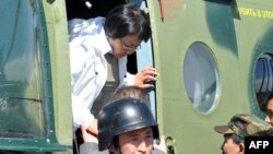 Interim leader Roza Otunbaeva exits her helicopter upon arrival in Osh on June 18.