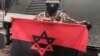 UKRAINE – Soldier keep flag of Ukrainian nationalists with Star of David