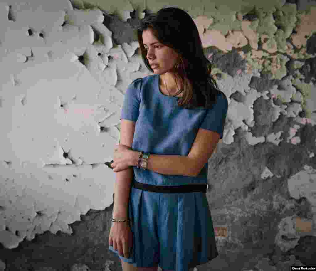 Amina Kachmazova stands in the cafeteria of School No. 1. She was just shy of her 8th birthday when she went to school on September 1, 2004. She walked there with two teenage neighbors, Lyalya and Alina. When the hostages were forced into the gymnasium, she had no relatives with her. She remembers the militants executing a man at the front of the hall to warn everyone to be quiet. Before those days, Amina had never heard of an "explosion." But by the end, she had lost an eye in the blasts that rocked through the room on the third day. Lyalya and Alina were killed. Ten years later, Amina is studying international relations at a university in Vladikavkaz. She laughs easily; she says she loves life. 