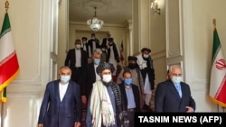 Iranian Foreign Minister Mohammad Javad Zarif (right) is shown meeting with Mullah Abdul Ghani Baradar (center) of the Taliban in Tehran in a photo from January 31.