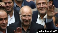 Mohammad Baqer Qalibaf (center) is surrounded by a group of lawmakers after being elected as speaker of the parliament in Tehran in May 2020.