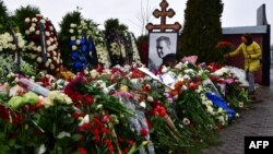 A mourner lays flowers on the grave of Russian opposition leader Aleksei Navalny at the Borisovo cemetery in Moscow on March 2.
