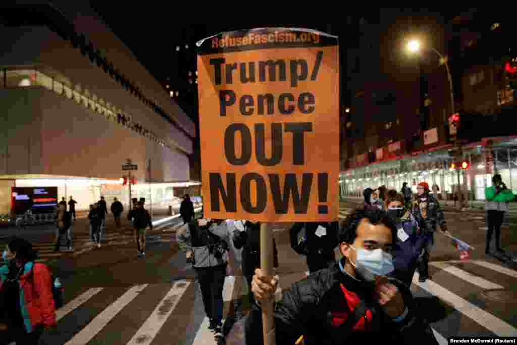 A protester holds a placard during a march against U.S President Donald Trump's administration on Election Day in New York City, New York, U.S. November 3, 2020. 