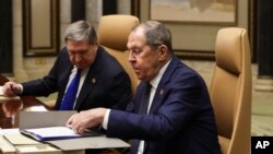 რუსეთის პრეზიდენტის თანაშემწე იური უშაკოვი(მარცხნივ) საგარეო საქმეთა მინისტრ სერგეი ლავროვთან ერთად მონაწილეობდა 2025 წლის 18 თებერვალს საუდის არაბეთში, აშშ-ის ოფიციალურ პირებთან შეხვედრაში.