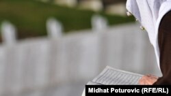 Starija žena čita molitvu u Memorijalnom centru Potočari