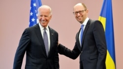 Ukrainian acting Prime Minister Arseniy Yatsenyuk (right) welcomes U.S. Vice President Joe Biden before their meeting in Kyiv today.