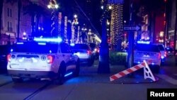 Police attend the scene where a pickup truck drove into a large crowd on Bourbon Street in New Orleans