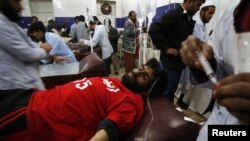 PHOTO GALLERY: A string of bombings kills scores in Pakistan. 