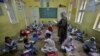 Students attend a class in Peshawar during the first day of primary school after the resumption of classes on September 30.