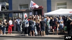 Переселенцы получают гуманитарную помощь в пункте выдачи Российского Красного Креста в Курске 15 августа 2024 года после наступления украинских войск на запад Курской области