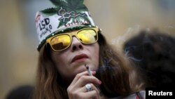 A woman smokes during a rally in support of the decriminalization of marijuana in Tbilisi in 2015.