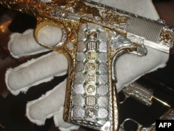 Инкрустированный и украшенный золотом, серебром и изумрудами пистолет Colt M1911, конфискованный во время ареста у одного из бандитов картеля "Синалоа". 2010 год