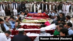 Mourners gather to attend a funeral for the victims of a blast at amarket in Quetta on April 12.