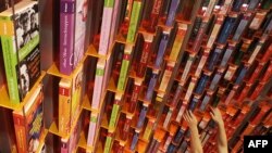 Cпівробітниця видавничого дому розставляє книжки на полицях перед відкриттям 61-го Франкфуртського книжкового ярмарку, 13 жовтня 2009 р.