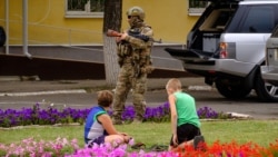 A Ukrainian serviceman stands guard in the city of Schastye in the Luhansk region late last month.