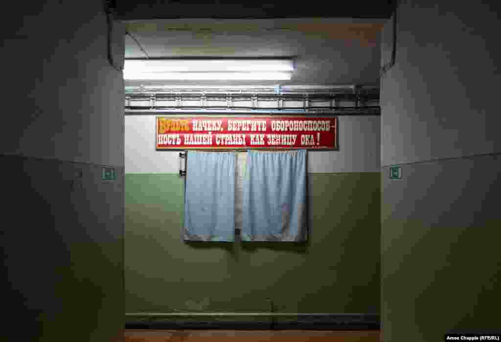 Находясь в бомбоубежище, не стоило забывать о главном – советской пропаганде. Номенклатура даже внутри бункера напоминала себе самой свои лозунги. А может быть, это написано для охраны?  За занавесками – план бомбоубежища. 