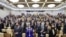 Russia -- Attendees stand during a plenary meeting of the Russian State Duma