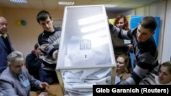 Члени виборчої комісії на одній з виборчих дільниць у місті Києві (ілюстраційне зображення) 