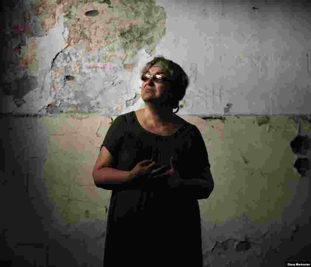 Nadezhda Guriyeva, 54, a history teacher, stands in the classroom at School No. 1 where she taught for more than 20 years. The curtains she put up with her son, Boris, still hang in the windows. Nadezhda -- or Nadya, as she prefers -- was taken hostage with her three children. Boris and her older daughter, Vera, died and their bodies burned in a fire sparked by explosives on the last day of the siege. They were 14 and 11. Boris and Vera had been scheduled to perform a dance at the school to mark the first day back. Vera's body was identified by the dress she had worn specially for the dance. Nadya and her youngest daughter escaped. Nadya now teaches in a new school built across from School No. 1. 