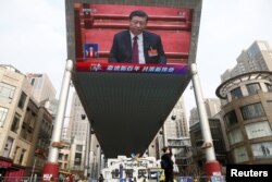 Džinovski ekran prikazuje kineskog predsednika Si Đinpinga na završnoj sednici Nacionalnog narodnog kongresa u Velikoj sali naroda u Pekingu 11. marta.